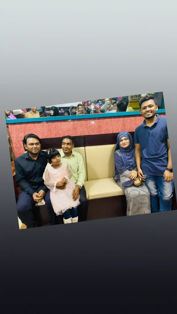 Group of five people posing for a photo on a beige sofa