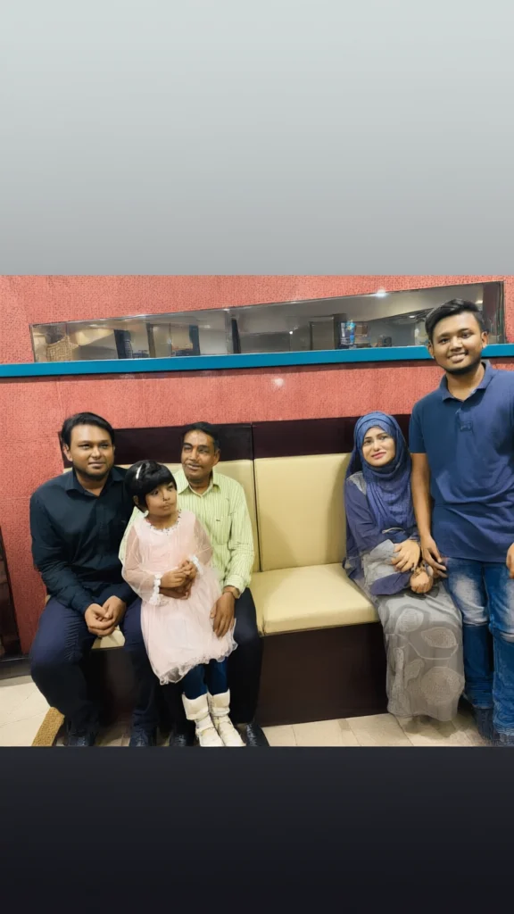 A group of five people including a child posing for a photo