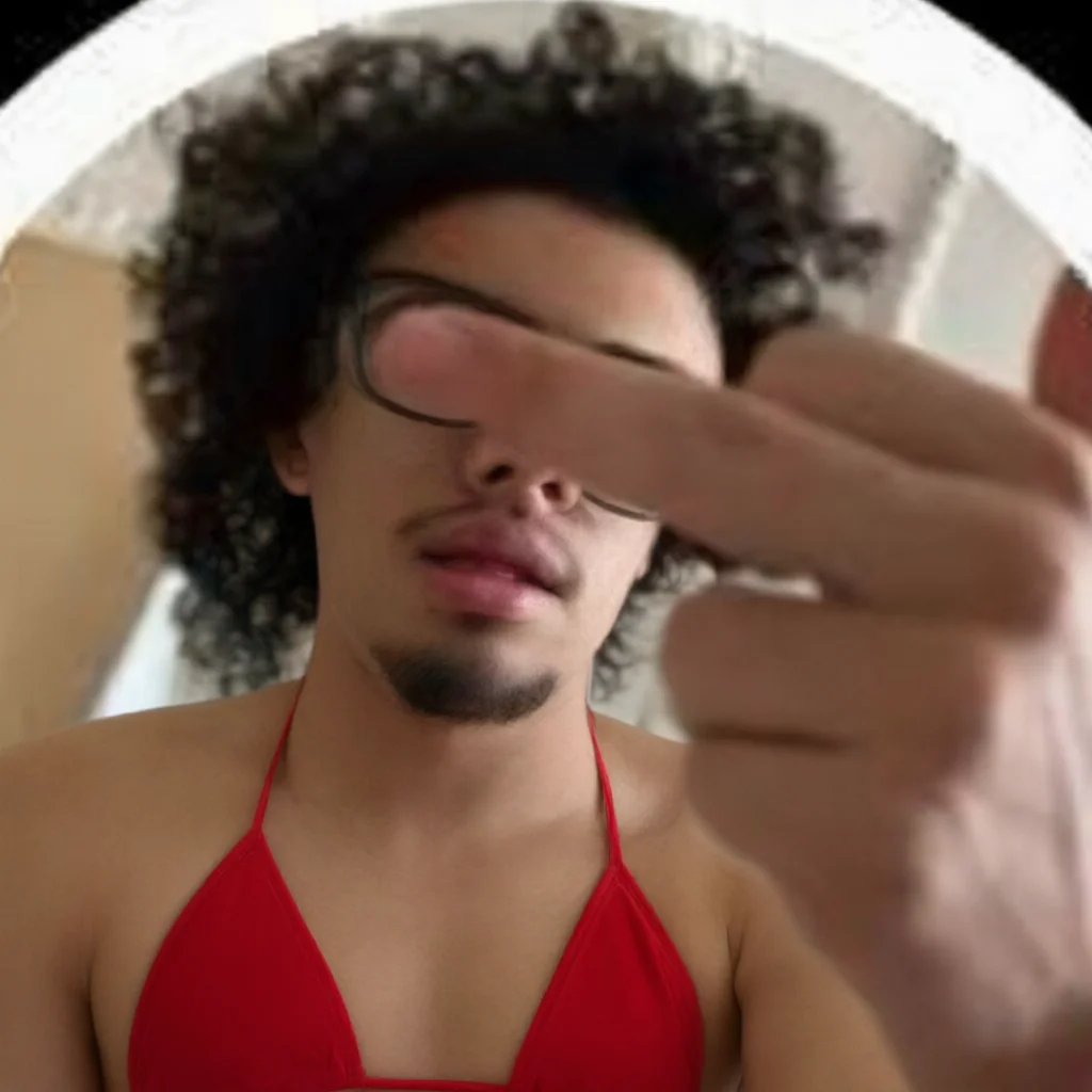Man in red bikini top instead of swim trunks
